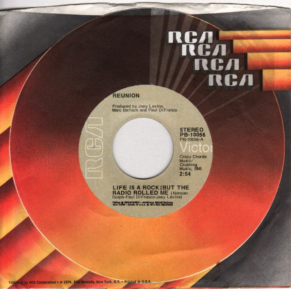 Reunion (3) : Life Is A Rock (But The Radio Rolled Me) (7", Single, Ind)