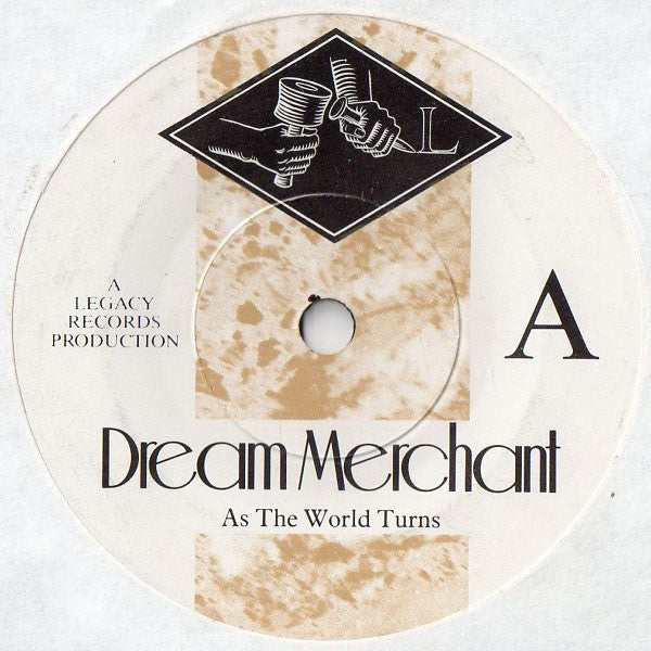 Dream Merchant : As The World Turns (7", Single, Com)